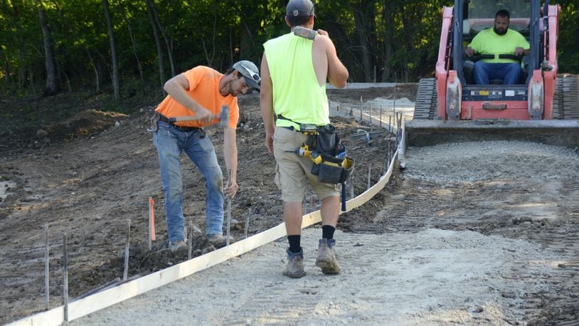 Crews work pictured on Aug. 7 on completing the multi-use and dog park at 6611 River Road in Fairfield, which will be called FurField. Construction is expected to wrap up in September. MICHAEL D. PITMAN/STAFF