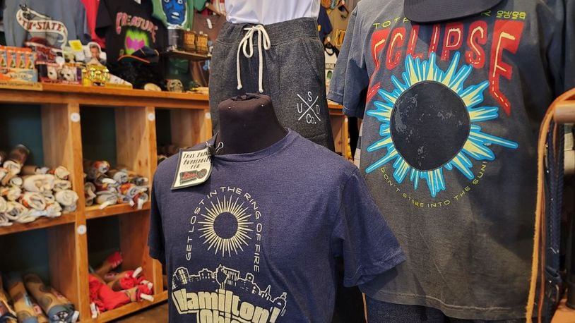 Many businesses in the area have eclipse merchandise like these shirts at Unsung Salvage Design Company in Hamilton. NICK GRAHAM/STAFF