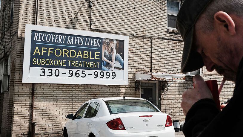 YOUNGSTOWN, OH - JULY 14:  A man walks by a billboard for a drug recovery center in Youngstown on July 14, 2017 in Youngstown, Ohio. Youngstown, a city that was once one of the nation's manufacturing hubs, has been struggling with high unemployment and a surge in opioid addiction.  (Photo by Spencer Platt/Getty Images)