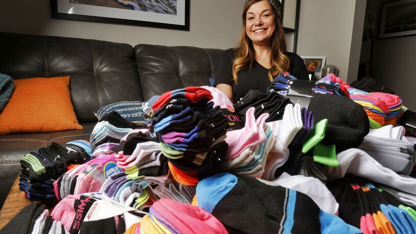 Monique Runzer collected socks and other items for her Socks for Hamilton Youth program. This was her third year of gathering socks to give to local youth in need through the Caring Closet. NICK GRAHAM / STAFF