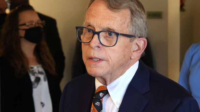 Governor Mike DeWine speaks to members of the media as he tours the vaccination clinic at New Carlisle Senior Living Friday morning. BILL LACKEY/STAFF