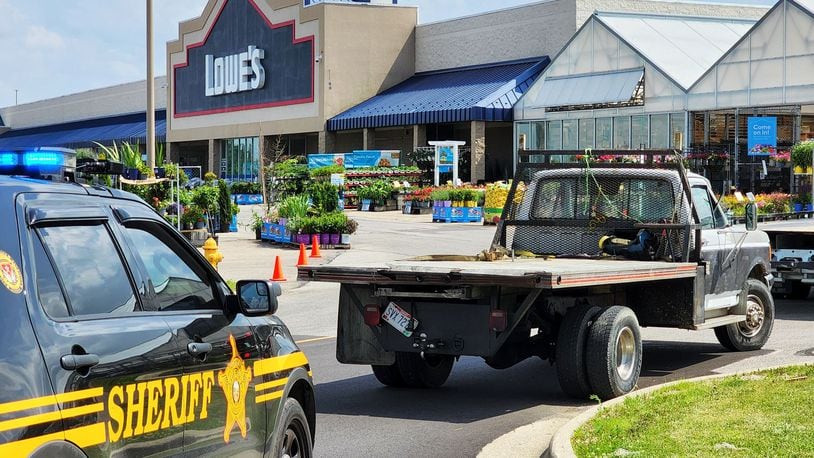 A man allegedly wanted on felony warrants ran from his truck at Lowe's in Hamilton Thursday afternoon. NICK GRAHAM/STAFF