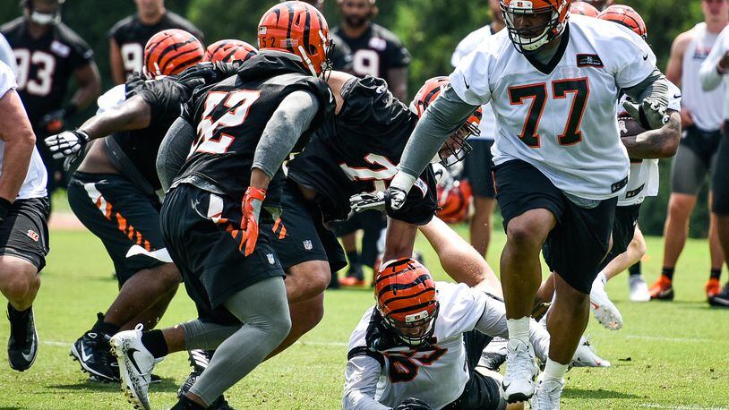 Bengals’ linebacker Preston Brown (52) prepares to meet offensive tackle Cordy Glenn (77) during a drill during organized team activities Tuesday, May 22, 2018, at the practice facility near Paul Brown Stadium in Cincinnati. OTAs continued on Tuesday. NICK GRAHAM/STAFF