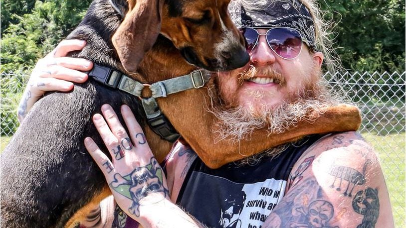 Wrestler "Heavy Metal Viking Hooks" recently posed with Turbo for a calendar and event Friday, July 16, that will benefit the Animal Adoption Foundation in Hamilton. PROVIDED