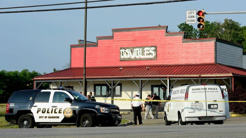 This was the scene after a 2 a.m. July 24 at Doubles Bar shooting on Main Street in Hamilton left one person dead and others wounded. Hamilton police investigated and collected evidence well into the morning. NICK GRAHAM/STAFF