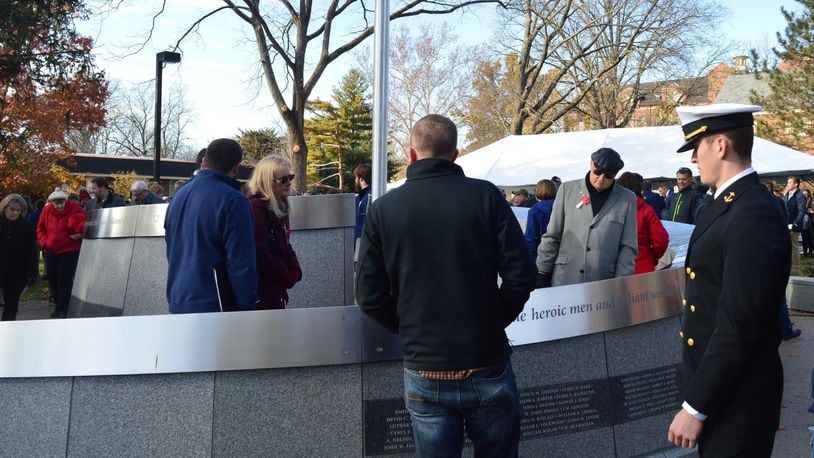 Visitors moved quickly for a closer viewing of the Miami University Alumni Veterans Tribute following the end of the formal dedication ceremony Nov. 11, to read the names and quotes up close and share in the experience. CONTRIBUTED/BOB RATTERMAN