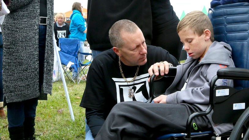 Kirk Bradley talks with his son, Kyler Bradley, during a fundraiser in October. Kyler has DIPG, an inoperable brain cancer that attacks brain stems and nervous system functions. GREG LYNCH / STAFF
