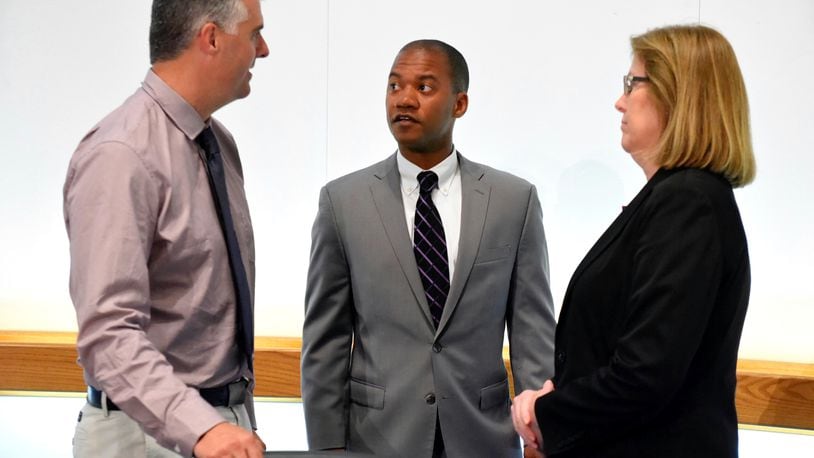 The Middletown City School District Board of Education announced during their meeting Monday night, May 22, that Marlon Styles, Jr. (middle) will be the new superintendent of the school district. Styles speaks with school board president Chris Urso, left, and vice president Marcia Andrews after the announcement.