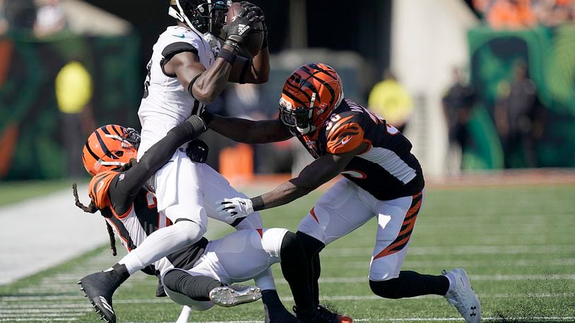 CINCINNATI, OHIO - OCTOBER 20: Chris Conley #18 of the Jacksonville Jaguars is tackled by Shawn Williams #36 and Torry McTyer #20 of the Cincinnati Bengals at Paul Brown Stadium on October 20, 2019 in Cincinnati, Ohio. (Photo by Bryan Woolston/Getty Images)