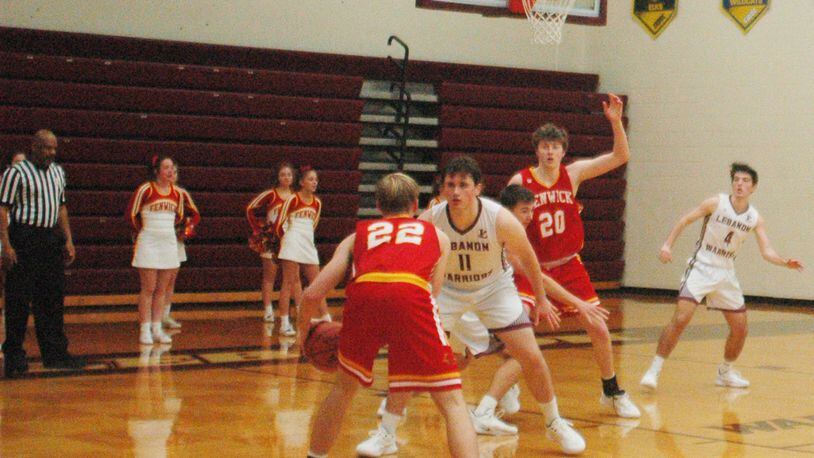 Fenwick’s C.J. Napier (22) looks inside toward teammate A.J. Braun (20) as Lebanon’s Zach Huffman (11) defends Saturday night at Lebanon. Napier’s two free throws with 3.7 seconds left gave the Falcons a 44-43 victory. RICK CASSANO/STAFF
