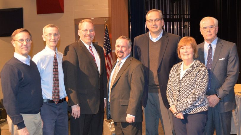 Ed Theroux, center, poses with Talawanda district officials following the board meeting Monday when he was formally hired to be the next superintendent. Pictured are, from lef, board members Chris Otto, Patrick Meade, Michael Crowder, Theroux, Mark Butterfield and Mary Jane Roberts and District Treasurer and CFO Mike Davis. CONTRIBUTED/BOB RATTERMAN