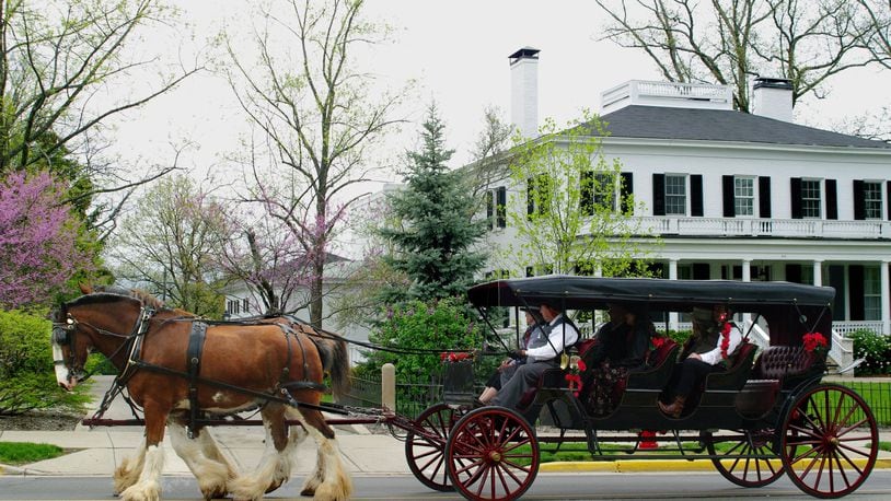 A Clydesdale-drawn carriage passes in front of Lewis Place, the home of Miami University’s presidents, during a previous Red Bricks and Roses event. CONTRIBUTED
