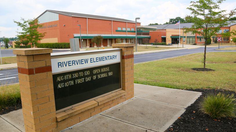 Hamilton school officials are asking city police for increased patrols around Riverview Elementary, the school near the site of Wednesday’s double homicide shooting. GREG LYNCH / STAFF