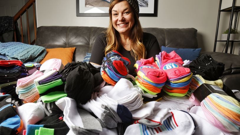 Monique Runzer is collecting socks for her Socks for Hamilton Youth program. This is her third year and is on her way to collecting 2000 pairs of socks to give to local youth in need. NICK GRAHAM / STAFF