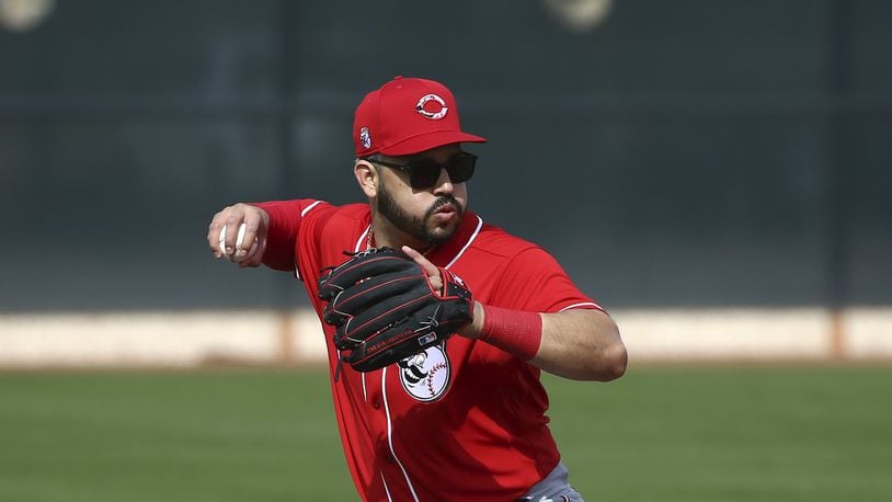 Cincinnati Reds third baseman Eugenio Suarez throws to first base during spring training baseball workouts Friday, Feb. 21, 2020, in Goodyear, Ariz. (AP Photo/Ross D. Franklin)