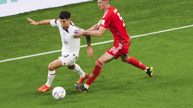 U.S. forward Christian Pulisic (10) and Wales defender Chris Mepham (5) during the first half of a World Cup soccer match between the U.S. and Wales at Ahmad Bin Ali Stadium in Doha, Qatar, on Monday, Nov. 21, 2022. (Erin Schaff/The New York Times)