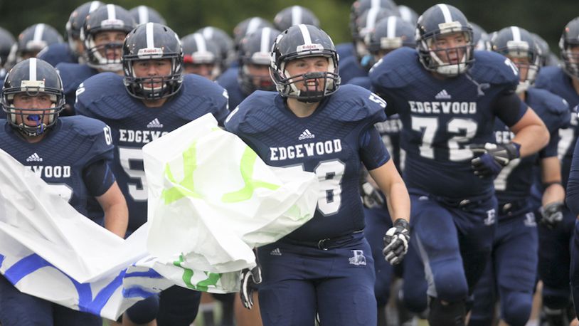 Edgewood defensive lineman Justin Pottorf (58), leads his team onto the field for their home game against Badin, Friday, Sept. 12, 2014. GREG LYNCH / STAFF