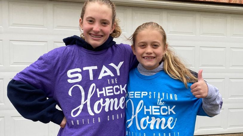 Kaylyn, 12, and Molly Macechko, 9, have spreading the message wearing their own pastel t-shirts with Butler County Health Commissioner Jennifer Bailer’s slogan “Stay the Heck Home, and creating positive messages via chalk art during their break from Tawlawada schools. SUBMITTED