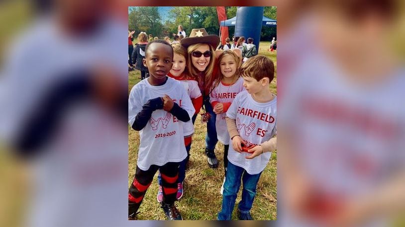 Fairfield West Elementary Principal Missy Mueller, pictured here with students, learned in June she had been stricken with myelodysplastic syndrome (MDS), which is a rare group of disorders in which your body no longer makes enough healthy blood cells. She decided to go public and campaign for all those battling illnesses who need donors to survive. (Provided Photo\Journal-News)