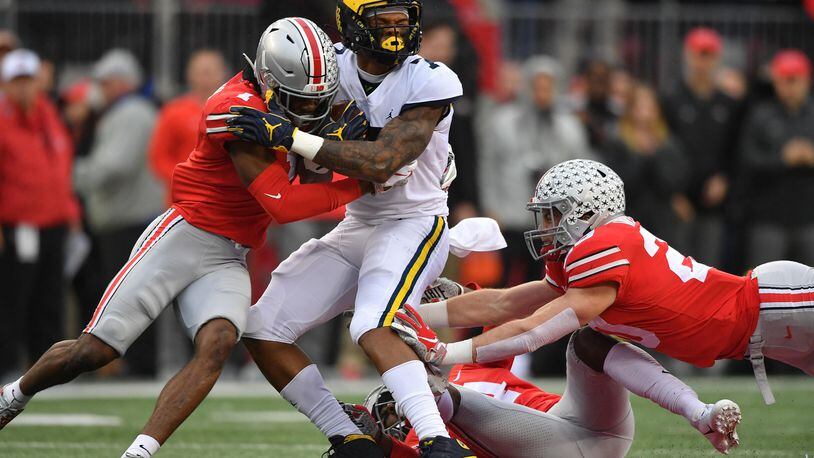 COLUMBUS, OH - NOVEMBER 24: Jeffrey Okudah #1 of the Ohio State Buckeyes hits Tarik Black #7 of the Michigan Wolverines in the first quarter after a gain at Ohio Stadium on November 24, 2018 in Columbus, Ohio. (Photo by Jamie Sabau/Getty Images)