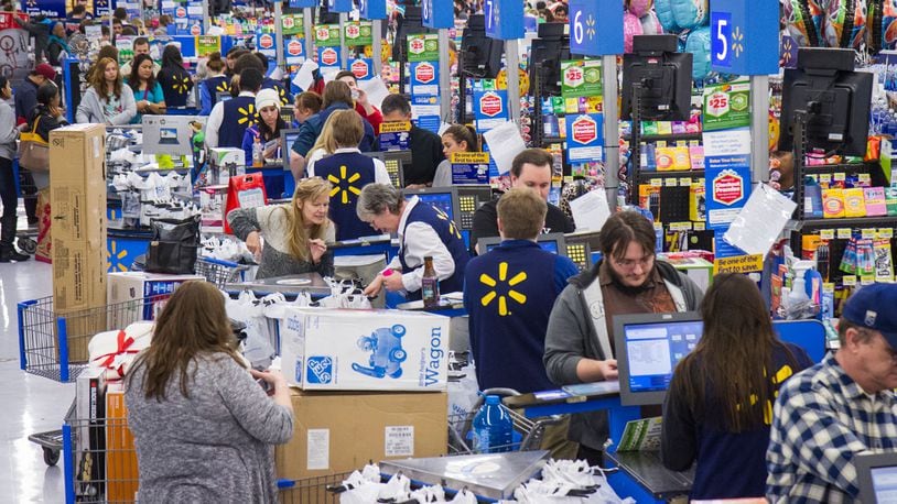 File photo: Shoppers purchase items for the holidays. An 11-year-old in Massachusetts paid off a layaway account at his local Walmart for a stranger.