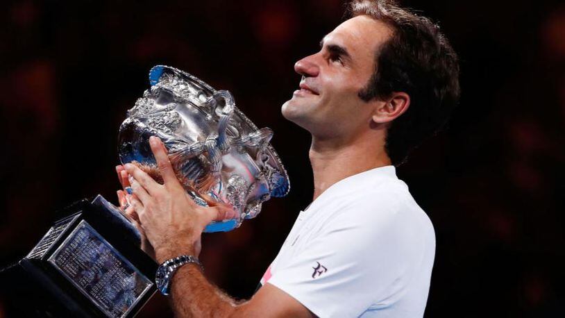 Roger Federer holds the Norman Brookes Challenge Cup after winning the 2018 Australian Open men's singles final against Marin Cilic of Croatia on Sunday.