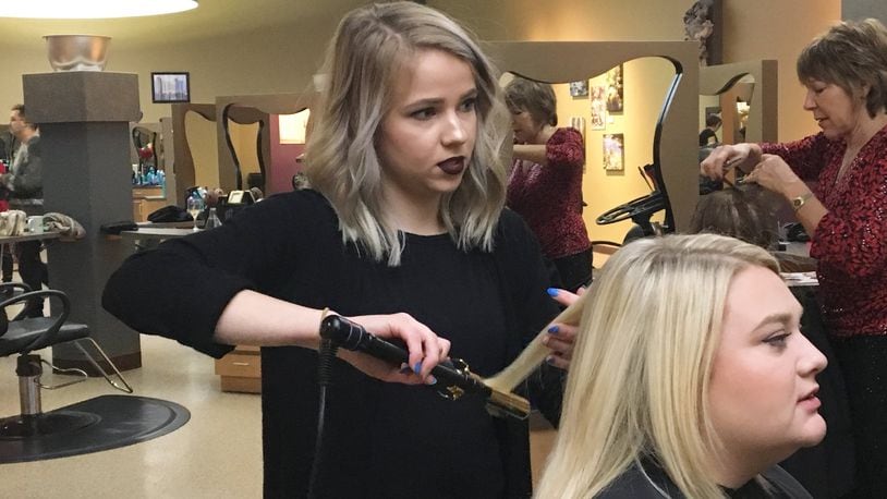 Rylie Myers, a 2016 graduate of the Miami Valley Career Technology Center, now works as a cosmetologist at Michael’s Salon and Spa in Centerville. Ohio lawmakers are considering lowering the number of training hours needed to be a licensed cosmetologist in the state. KATIE WEDELL/STAFF
