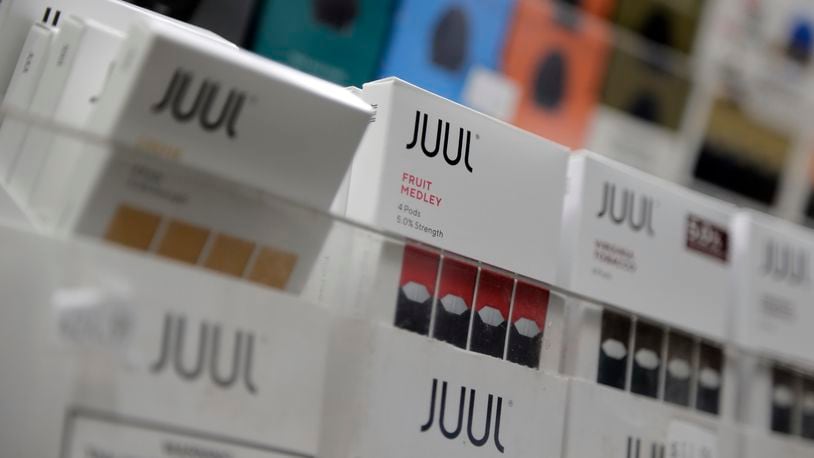 Juul vape products are displayed at a smoke shop. A bill that could loosen laws limiting e-cigarette and tobacco access for young people awaits Gov. Mike DeWine’s signature or veto. AP FILE