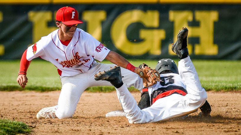 Fenwick’s R.J. Clesceri just misses the tag on Franklin’s Austin Gilbert during the host Falcons’ 1-0 win in a Division II sectional game May 10, 2017. NICK GRAHAM/STAFF