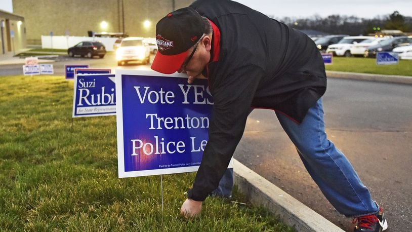 Voters overwhelmingly approved a 5.25 mill permanent police levy in March which has had a big impact on the city’s 2017 budget. Pictured here is Trenton City Manager John Jones putting up signs supporting the Trenton police levy on March 15 at Edgewood Middle School in St. Clair Township. NICK GRAHAM/STAFF