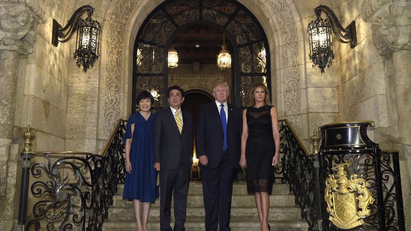 President Donald Trump, second from right, and first lady Melania Trump, right, stop to pose for a photo with Japanese Prime Minister Shinzo Abe, second from left, and his wife Akie Abe, left, before they have dinner at Mar-a-Lago in Palm Beach, Fla., Saturday, Feb. 11, 2017. (AP Photo/Susan Walsh)
