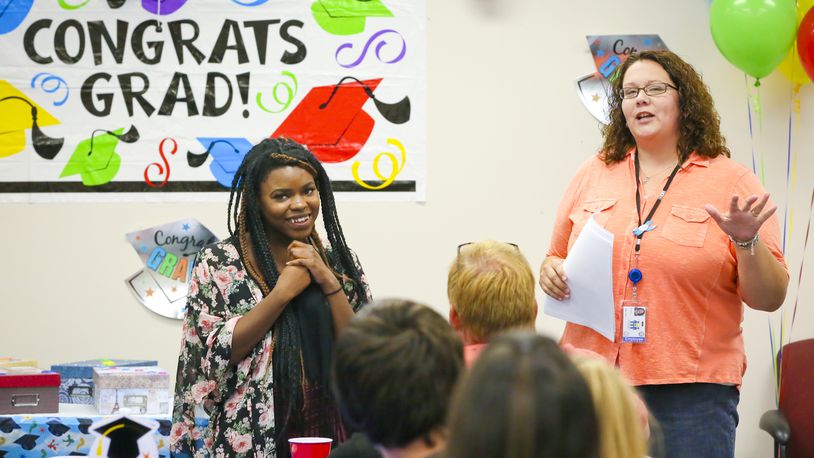 Butler County Children Services Independent Living and Emancipation Coordinator Abby Sexton, right, talks about Trenae, during their annual graduation ceremony for emancipated youth on Thursday, June 25, 2015. Trenae has not only graduated from high school but recently graduated from Miami University. GREG LYNCH / STAFF