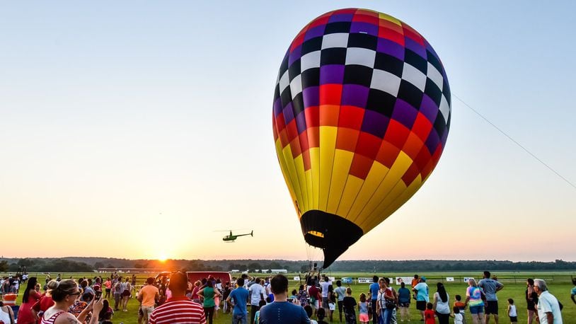 Balloon enthusiasts gather for the balloon glow during The Ohio Challenge hot air balloon festival Friday, July 19, 2019 at Smith Park in Middletown. NICK GRAHAM/STAFF