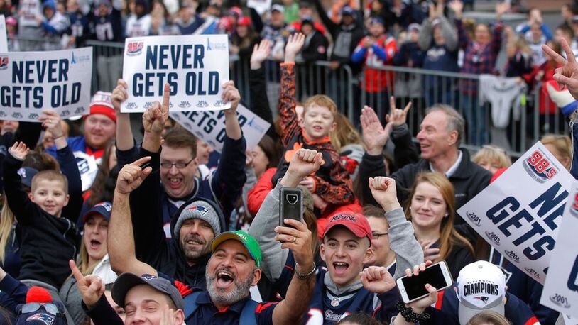 Fans wait for the New England Patriots parade to through downtown Boston, Tuesday, Feb. 5, 2019, to celebrate their win over the Los Angeles Rams in Sunday's NFL Super Bowl 53 football game in Atlanta.