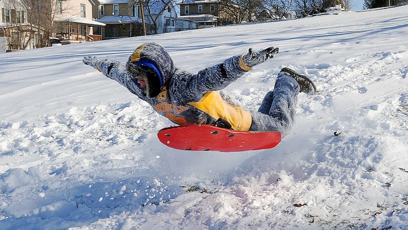Adrian Jaynes, 15, flies in the air sledding down the hill at Standpipe Park. MARSHALL GORBY / STAFF