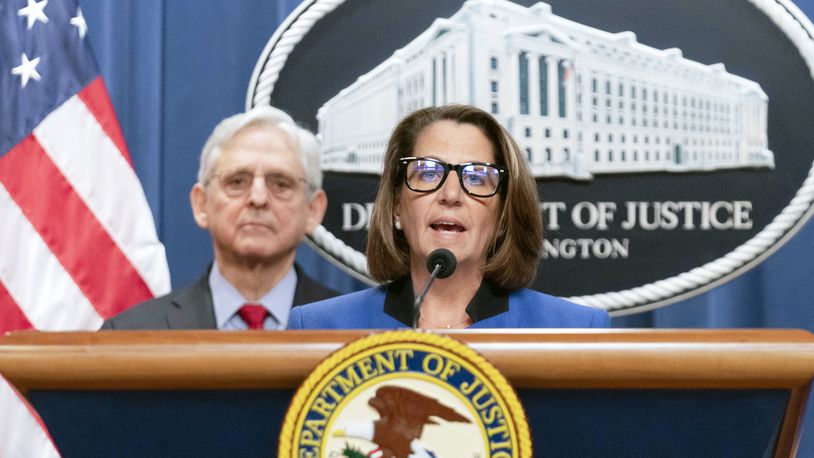 FILE - Deputy Attorney General Lisa Monaco speaks as Attorney General Merrick Garland listens during a news conference at Department of Justice headquarters in Washington, March 21, 2024. The Justice Department is ramping up its efforts to reduce violent crime in the U.S., launching a specialized gun intelligence center in Chicago and expanding task forces to curb carjackings. Deputy Attorney General Lisa Monaco tells The Associated Press there's “absolutely much more to do” to make communities safer, even as many places have experienced a downward trend in crime after a coronavirus pandemic-era spike. (AP Photo/Jose Luis Magana)