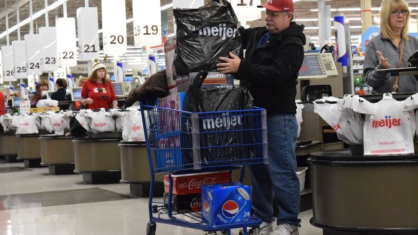 Hundreds of shoppers waited in lines at the Kettering Meijer Thanksgiving morning for televisions, Apple products and other deals. STAFF PHOTO / HOLLY SHIVELY