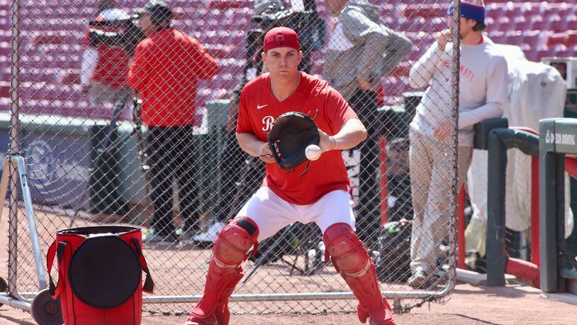 Reds catcher Tyler Stephenson warms up on Opening Day on Thursday, March 30, 2023, at Great American Ball Park in Cincinnati. David Jablonski/Staff