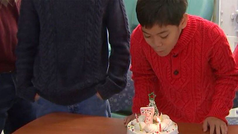 Jordan Ocampo, 10, blows out a candle on Tuesday, Dec. 24, 2019, to celebrate the seventh year since he underwent a successful kidney transplant in Charlotte, North Carolina.