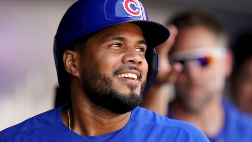 Chicago Cubs' Jeimer Candelario celebrates in the dugout after he hit a two-run home run against the Pittsburgh Pirates in the fourth inning of a baseball game in Pittsburgh, Sunday, Aug. 27, 2023. (AP Photo/Matt Freed)