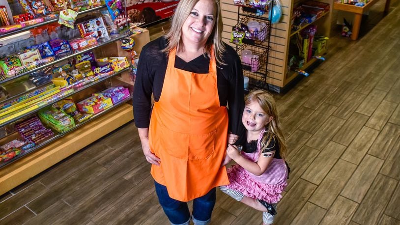 Missy Wagner stands with her daughter, Presley, 5, at Candy Stash Sweets & Treats Wednesday, Nov. 20, 2019 at 7125 Liberty Centre Drive in Liberty Township. Wagner opened Candy Stash in the space previously occupied by another candy shop. The location offers a variety of packaged and bulk candy, rolled ice cream, hand dipped ice cream, premium Philly Ice, specialty drinks and more. NICK GRAHAM/STAFF