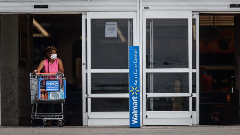 A Walmart shopper exits the store wearing a mask Thursday July 29, 2021 The CDC recommended on Tuesday that in areas with high community COVID-19 transmission rates, fully vaccinated individuals should don a face mask. JIM NOELKER/STAFF