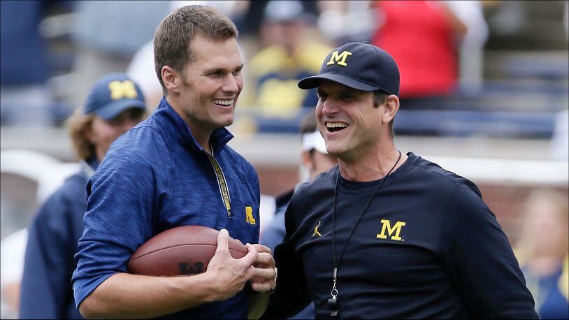 ANN ARBOR, MI - SEPTEMBER 17:  Quarterback Tom Brady of the New England Patriots laughs with head coach Jim Harbaugh of the Michigan Wolverines after they played catch before a game against the Colorado Buffaloes at Michigan Stadium on September 17, 2016 in Ann Arbor, Michigan. (Photo by Duane Burleson/Getty Images)