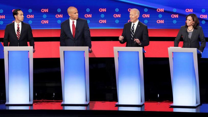 DETROIT, MICHIGAN - JULY 31: Democratic presidential candidate former Vice President Joe Biden (2nd R) speaks while Sen. Kamala Harris (D-CA) (R), Sen. Cory Booker (D-NJ) and former housing secretary Julian Castro listen during the Democratic Presidential Debate at the Fox Theatre July 31, 2019 in Detroit, Michigan. 20 Democratic presidential candidates were split into two groups of 10 to take part in the debate sponsored by CNN held over two nights at Detroits Fox Theatre. (Photo by Scott Olson/Getty Images)