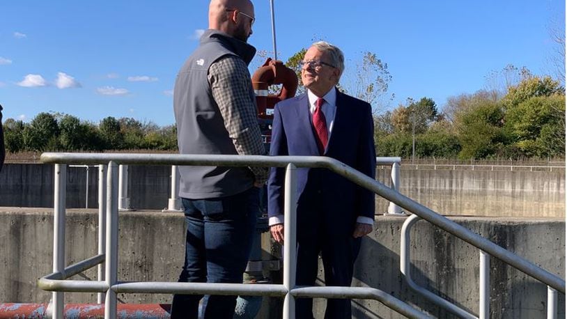 Lebanon's then-Vice Mayor Mark Messer, left, and Ohio Gov. Mike DeWine talk Oct. 26, 2021 about the  4-million-gallon Flow Equalization Tank at the Glosser Road Wastewater Pumping Station in Lebanon. FILE