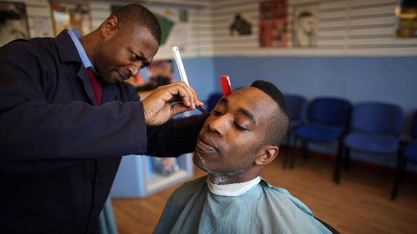 Barber and customer. (Photo credit: Christopher Furlong / Getty Images)