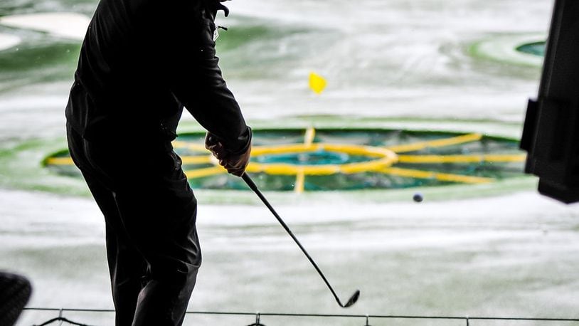 David Allen, Director of Instruction at TopGolf West Chester, hits a ball as the snow falls Thursday, Jan. 5. NICK GRAHAM/STAFF