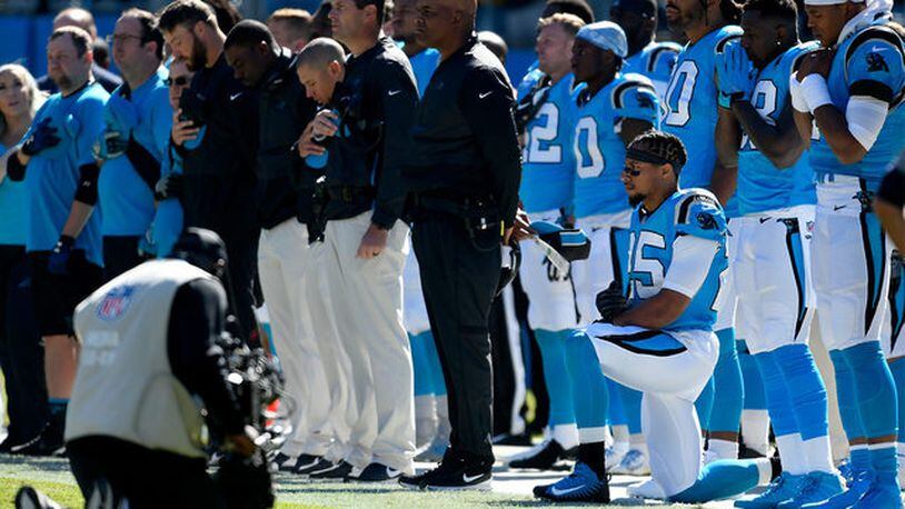 Eric Reid kneeled Sunday before the Panthers game against the Buccaneers. (Photos: WSOCTV.com)