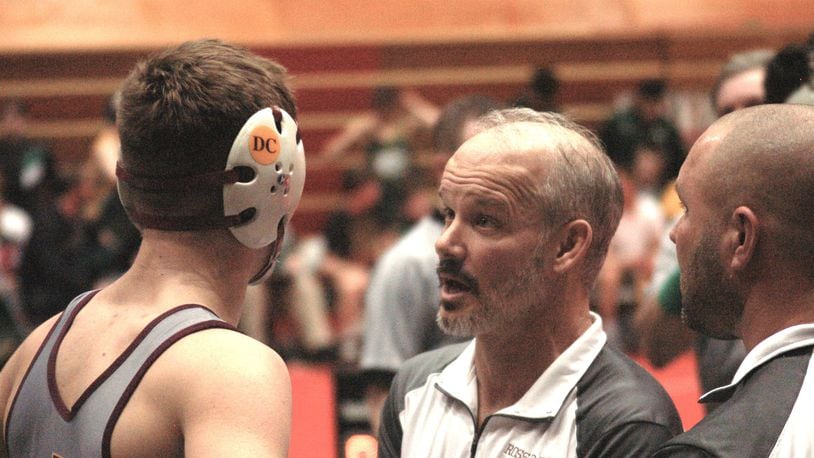 Ross head coach Rich Dunn talks things over with Logan Iams during his match against Akron St. Vincent-St. Mary Sunday at St. John Arena. Ross advance to the semis before falling to Mentor Lake Catholic. John Cummings/CONTRIBUTED