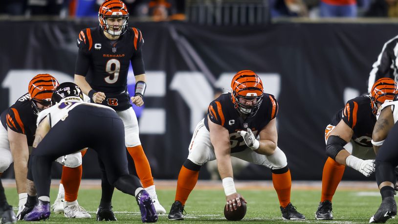 Bengals center Ted Karras gets ready to hike the ball to quarterback Joe Burrow during Cincinnati's AFC Wild Card playoff game against the Baltimore Ravens Sunday, Jan. 15, 2023 at Paycor Stadium in Cincinnati. The Bengals won 24-17. NICK GRAHAM/STAFF